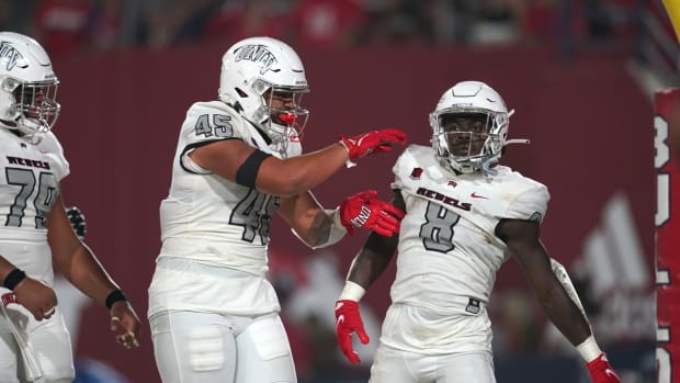 Sep 24, 2021; Fresno, California, USA; UNLV Rebels running back Charles Williams (8) is congratulated by tight end Giovanni Fauolo Sr. (45) after scoring a touchdown against the Fresno State Bulldogs in the first quarter at Bulldog Stadium. Mandatory Credit: Cary Edmondson-USA TODAY Sports